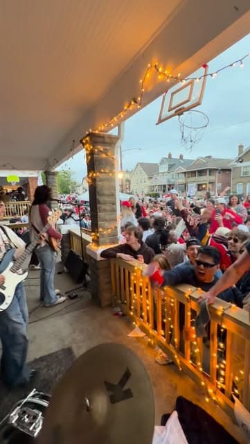 A packed street of fans at a Fretters block party show